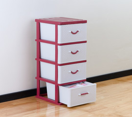 A plastic cabinet with drawers for home or office using
