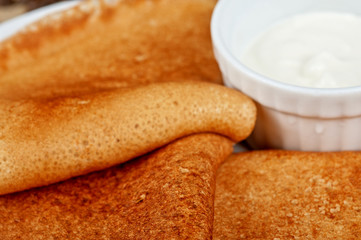 Fototapeta na wymiar pancakes with sour cream