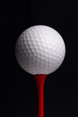 golf  tees with ball on black background