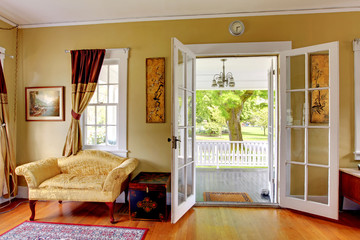 Living room with open doors to the front porch.