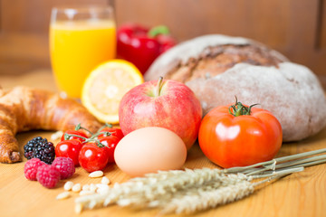 kitchen table with a lot of food like bread and vegetables