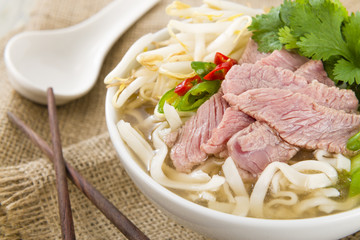 Pho Bo - Vietnamese rice noodle soup with beef, herbs and chili