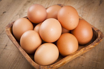 eggs in a bascket on wooden table