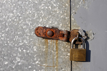 Steel doors locked with a rusty padlock