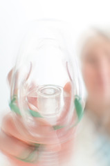 Female assisitant giving gas mask to patient