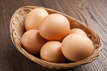 eggs in a bascket on wooden table