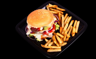 Hamburger with fries isolated on black background