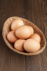 eggs in a bascket on wooden table
