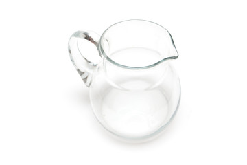 On a white background is a glass jug for milk
