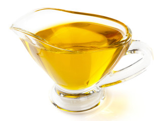 Olive oil in gravy boat, isolated on white