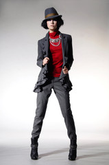 Full length fashion girl in hat posing on light background