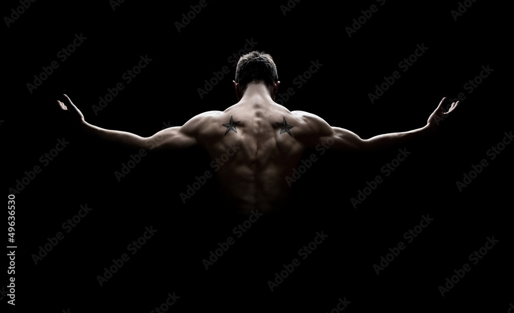 Wall mural rear view of healthy young man with arms stretched out