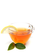 Glass cup of tea with a slice of lemon on a white background.