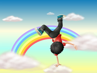 Een jongen die een breakdance uitvoert langs de regenboog