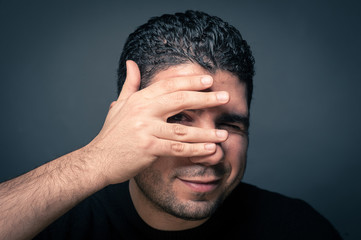 Fototapeta premium Man joking close up portrait against dark background.
