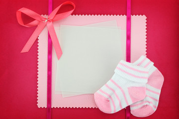 Blank card with baby socks on blue background