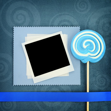 Photo frame and lollipop on blue background