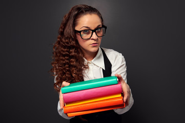 young teacher in glasses offering books