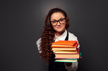 young teacher offering books with smile