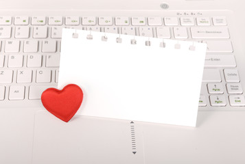 red hearts and sticky note on Laptop keyboard