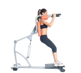 Fototapeta premium Beautiful slim woman trains on exerciser