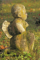 old damaged angelic statue on Rakowice cemetery, Krakow, Poland