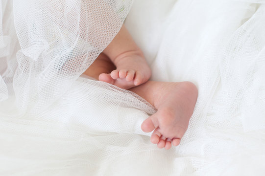 Baby feet in a white diaper