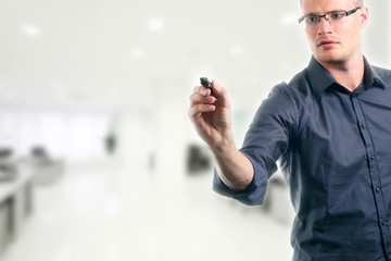 young man writing something with marker in the office