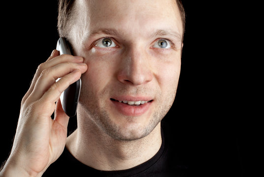 Young Caucasian man talks on mobile phone