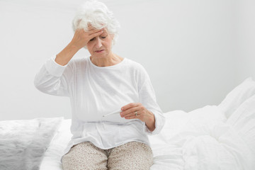 Aged woman suffering with fever