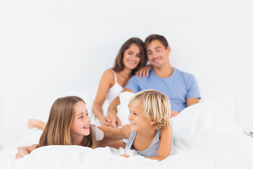 Smiling children lying on the bed