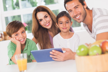Happy family using a tablet pc
