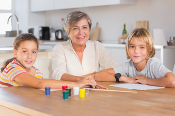 Granny and her grandchildren looking at camera with smile