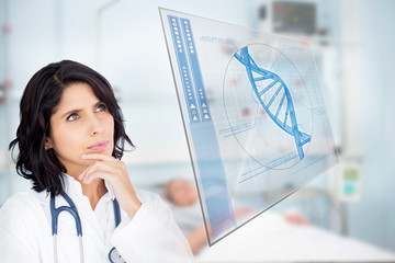Doctor looking up at screen showing blue DNA helix data