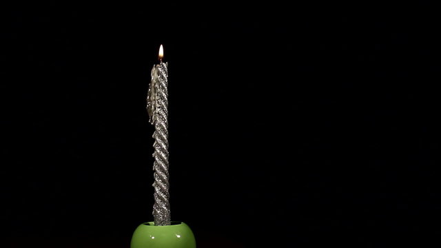 Burning-down silvery candle. Time lapse