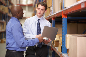 Two Businessmen With Laptop In Warehouse