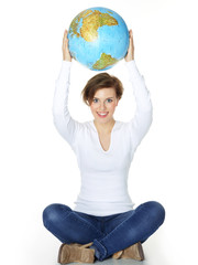 Woman holds the world globe over her head