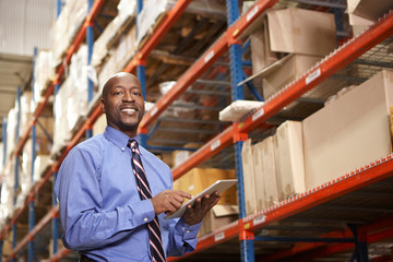 Businessman With Digital Tablet In Warehouse