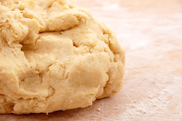 Fresh pastry on a floured wooden board