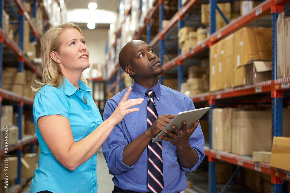 Wall mural businesspeople with digital tablet in warehouse