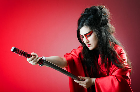 Female sword warriod in dark studio