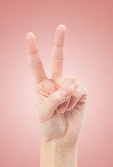 Hand with two fingers up in the peace or victory symbol. Also th
