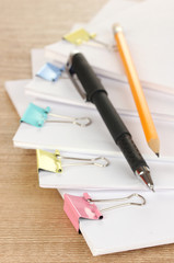 Documents with binder clips on wooden table
