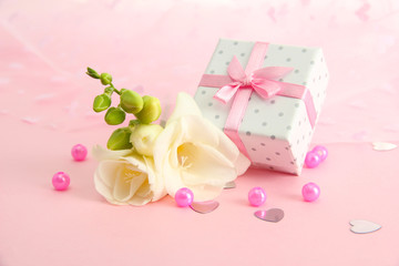 Obraz na płótnie Canvas Beautiful romantic gift box and flower on pink background