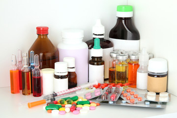 Medical bottles and pills on shelf
