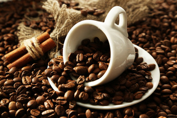 Cup with coffee beans, close up