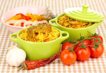 Delicious pilaf with vegetables on tablecloth background