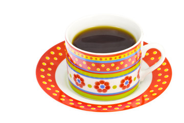 coffee poured into a coffee cup with a flower pattern