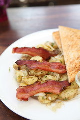 Breakfast of  bacon, toast and hash browns.