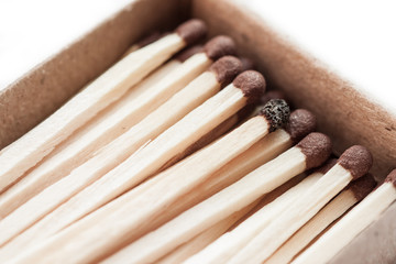 Matchbox and one burnt match isolated on white background.